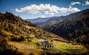 traditional house and rice field in the countryside of rural Bhutan.  Bhutan Photo tour with Adam monk